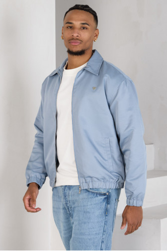 Veste bleue zippée à cœur sur la poitrine