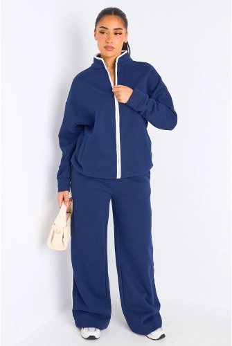 Ensemble deux pièces bleu à bandes blanches veste + jogging coupe droite