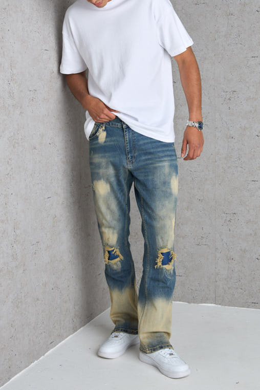 Jean bleu foncé coupe large délavé et taché