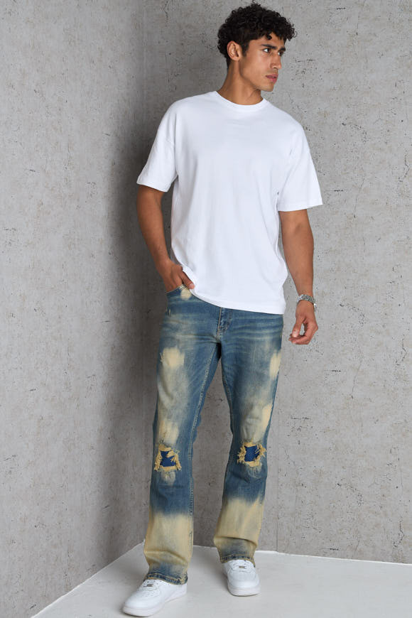 Jean bleu foncé coupe large délavé et taché